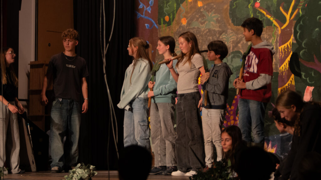 Kinder stehen bei einer Theateraufführung gemeinsam auf der Bühne.